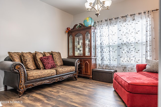 living room with an inviting chandelier, dark hardwood / wood-style floors, and a wealth of natural light