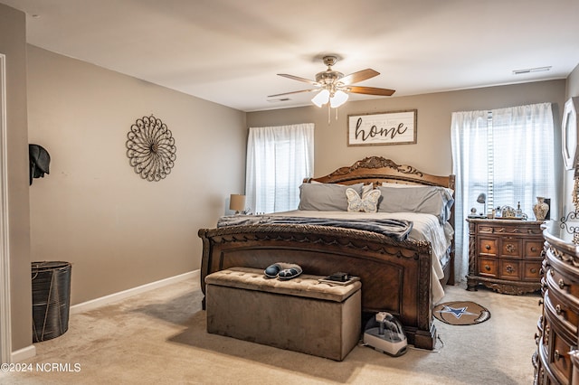 bedroom with light carpet and ceiling fan