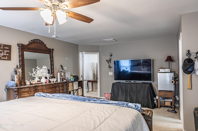 bedroom with light carpet and ceiling fan