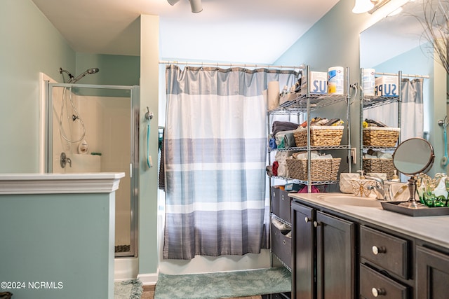 bathroom featuring a shower with curtain and vanity