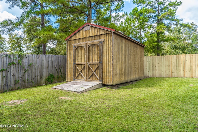 view of outdoor structure featuring a lawn