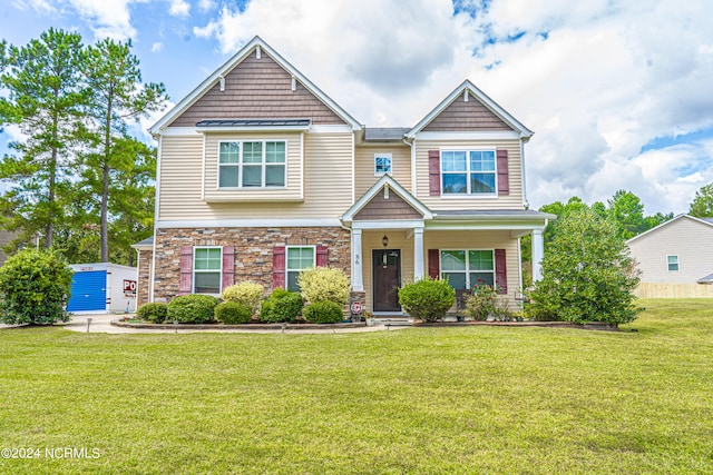 craftsman house with a porch and a front lawn