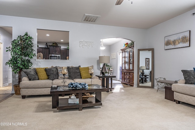 living room featuring ceiling fan and light carpet