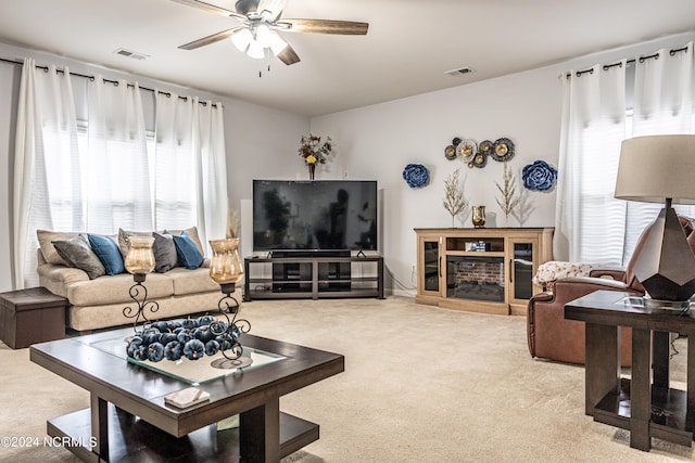 living room featuring a healthy amount of sunlight, carpet flooring, and ceiling fan