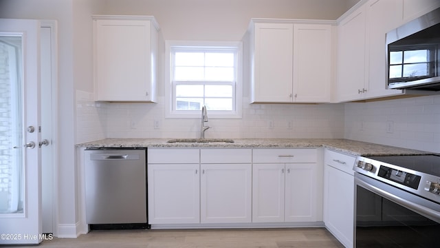 1254 Opaca Dr SE, Bolivia, NC 28422 - kitchen featuring appliances with stainless steel finishes, a sink, white cabinets, and backsplash