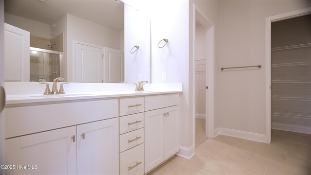 1254 Opaca Dr SE, Bolivia, NC 28422 - bathroom featuring double vanity, baseboards, and a shower stall