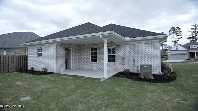 1254 Opaca Dr SE, Bolivia, NC 28422 - back of property featuring a shingled roof, a patio area, and brick siding