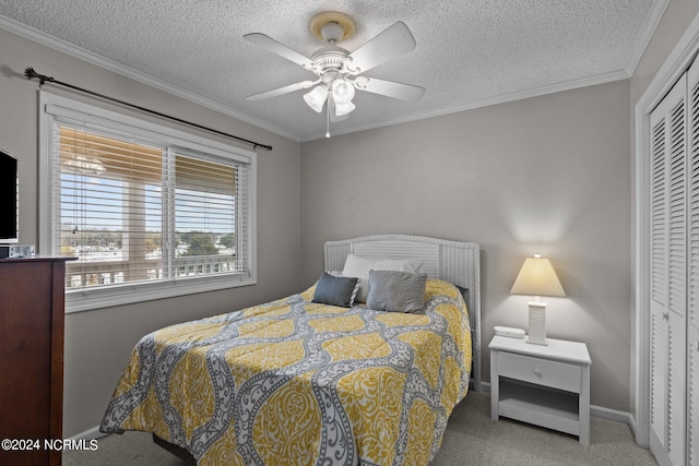 bedroom featuring a closet, ceiling fan, light carpet, a textured ceiling, and ornamental molding