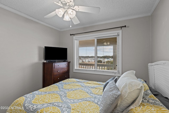 bedroom with ornamental molding, a textured ceiling, and ceiling fan