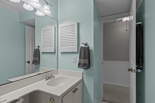 bathroom with vanity, a textured ceiling, and ceiling fan