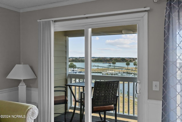 doorway to outside featuring crown molding and a water view