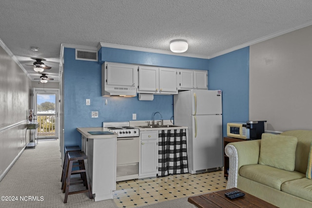 kitchen featuring white appliances, light colored carpet, ceiling fan, sink, and white cabinetry