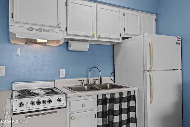 kitchen with white appliances, white cabinets, and sink