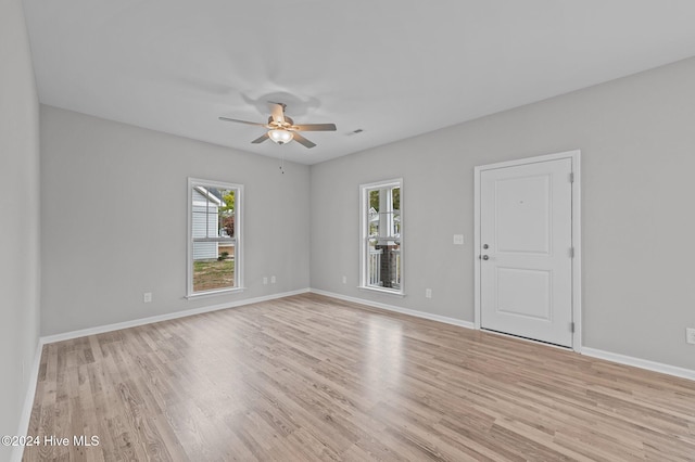 empty room with light wood-type flooring and ceiling fan