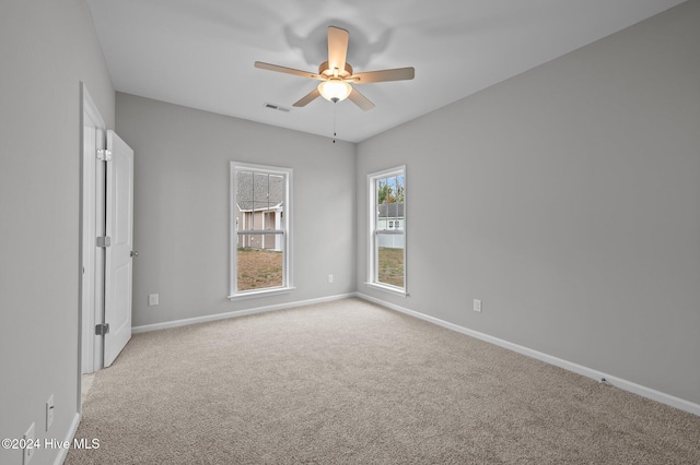 unfurnished room featuring light carpet and ceiling fan