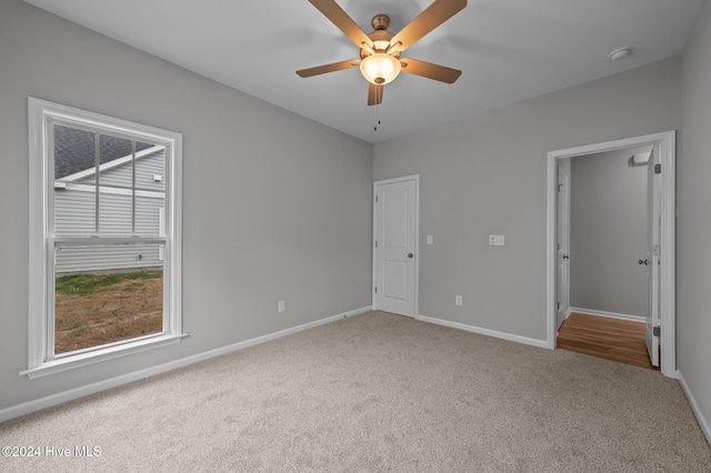 unfurnished bedroom with ceiling fan and carpet floors