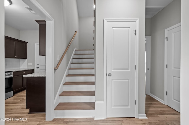 staircase with hardwood / wood-style flooring