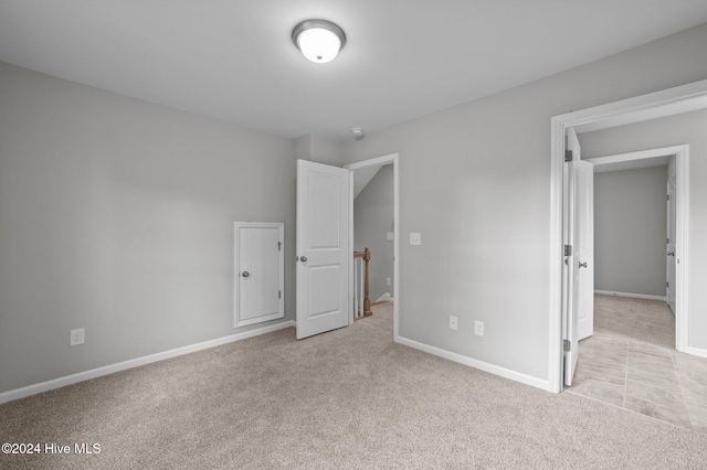 unfurnished bedroom with light carpet