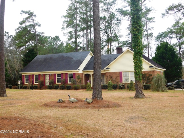 ranch-style home with a front lawn