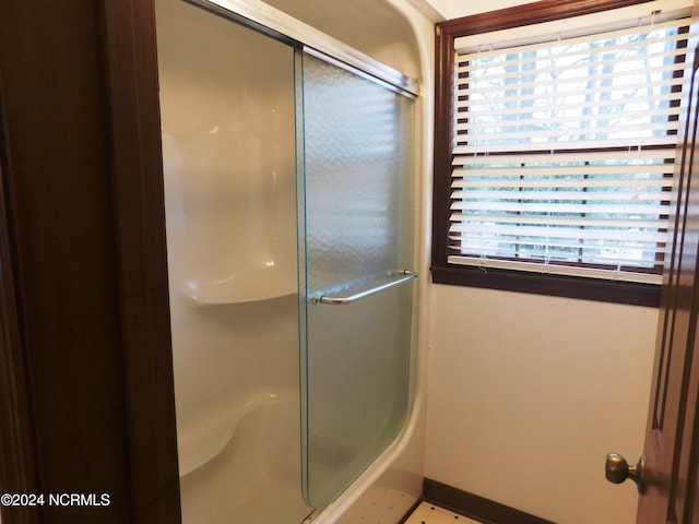 bathroom featuring a shower with shower door