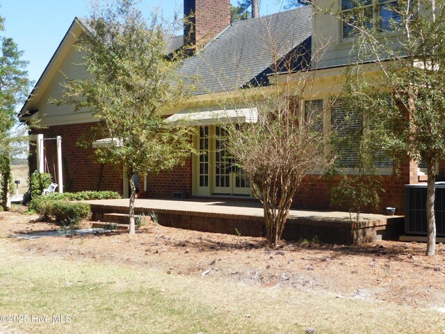 view of front facade with central AC and french doors