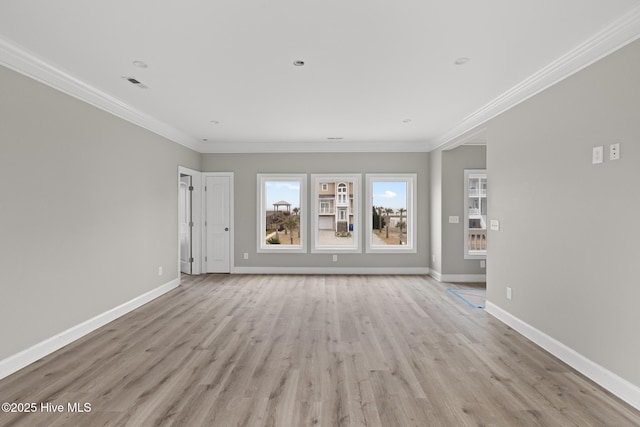 unfurnished living room with light wood-style floors, visible vents, baseboards, and crown molding