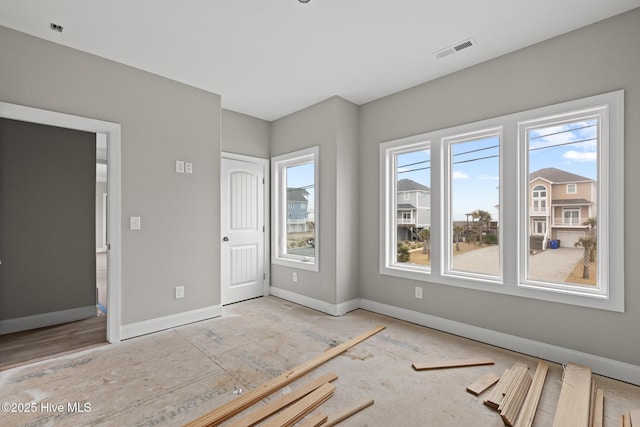 empty room featuring visible vents and baseboards