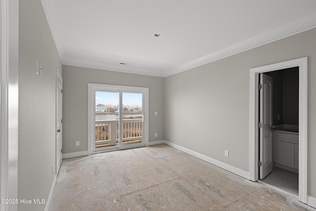 empty room featuring baseboards and ornamental molding