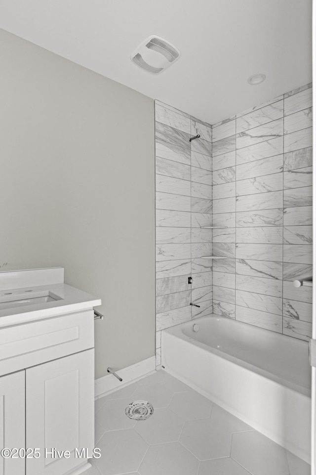 full bath featuring tile patterned flooring, visible vents, vanity, and shower / tub combination