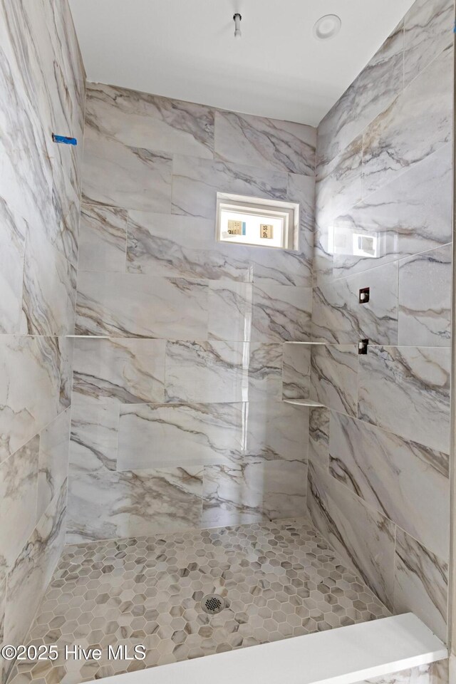 bathroom featuring tiled shower