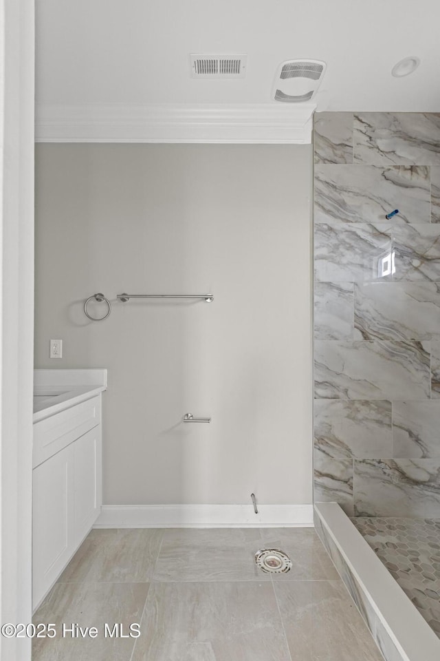 bathroom featuring baseboards, visible vents, ornamental molding, a tile shower, and vanity