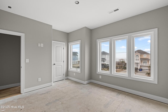 empty room with visible vents and baseboards