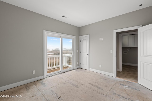 unfurnished bedroom with access to outside, visible vents, and baseboards