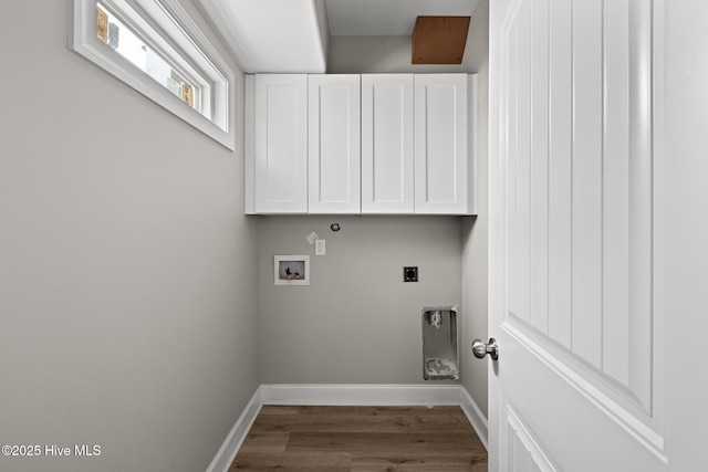 washroom with hookup for an electric dryer, washer hookup, wood finished floors, baseboards, and cabinet space