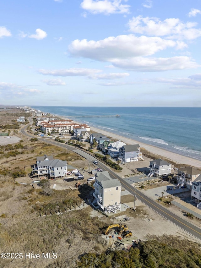 birds eye view of property featuring a water view and a view of the beach