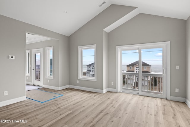 doorway with light wood-style flooring, plenty of natural light, visible vents, and baseboards