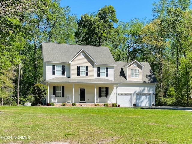 view of front facade with a porch, a garage, and a front yard