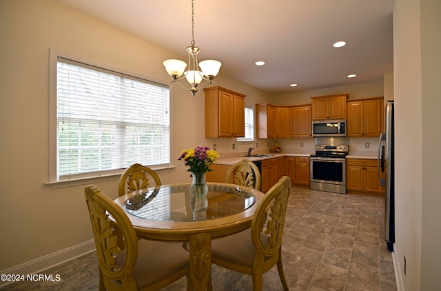 dining area featuring sink and a chandelier