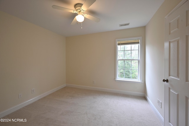 carpeted empty room featuring ceiling fan