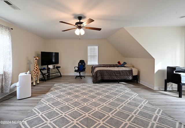 bedroom featuring wood-type flooring, ceiling fan, and vaulted ceiling