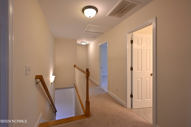 hallway featuring light carpet