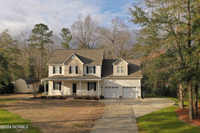 view of front of property featuring a storage shed, a front lawn, and covered porch