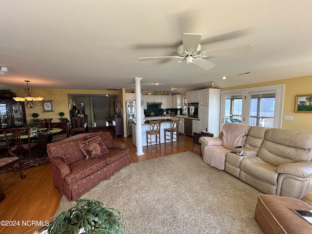 living room with ceiling fan, light hardwood / wood-style flooring, and decorative columns