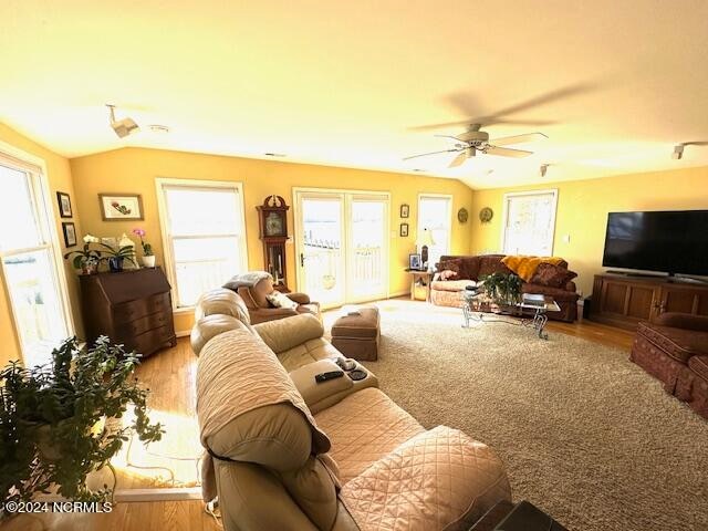 living room featuring light hardwood / wood-style floors and ceiling fan