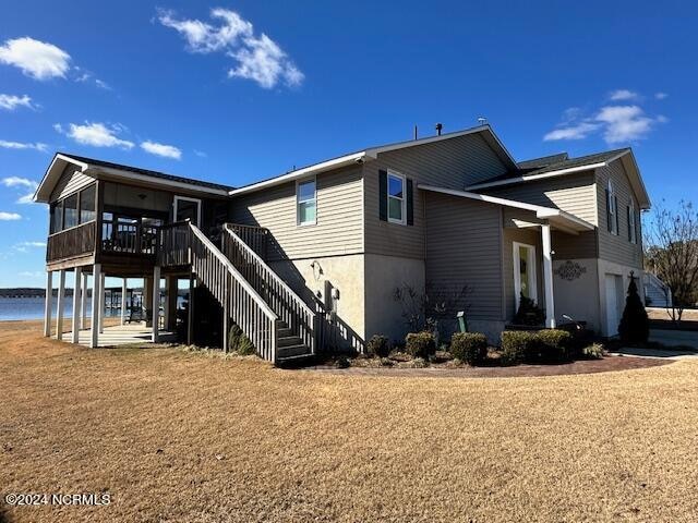 rear view of property featuring a deck