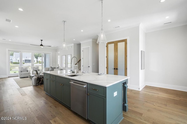 kitchen with light hardwood / wood-style floors, dishwasher, a kitchen island with sink, sink, and ornamental molding