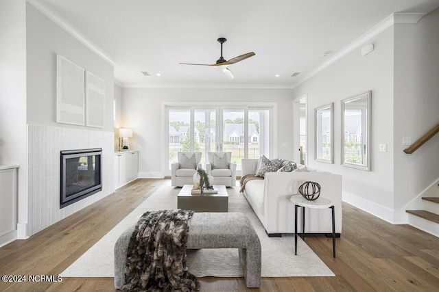 living room with ceiling fan, crown molding, and hardwood / wood-style floors