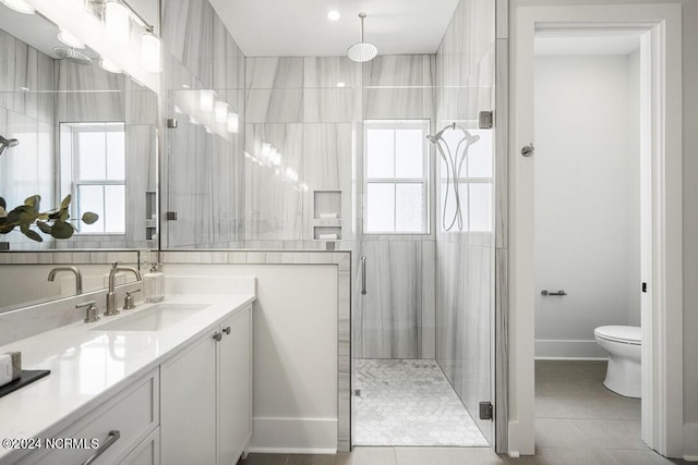 bathroom with toilet, tile patterned flooring, an enclosed shower, and vanity