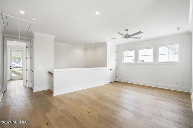 empty room with ceiling fan, light hardwood / wood-style flooring, and ornamental molding