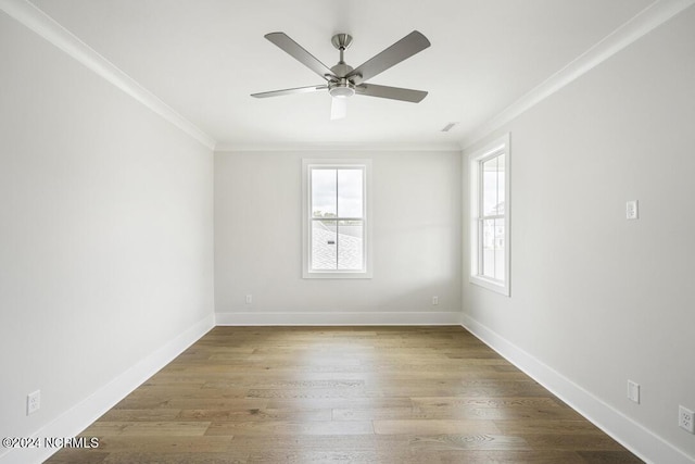 spare room featuring ceiling fan, wood-type flooring, and crown molding